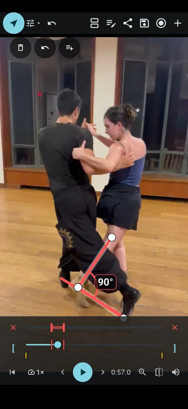 A tango couple paused mid-step in InForm, with an angle of 90 degrees measured between the leader's legs.